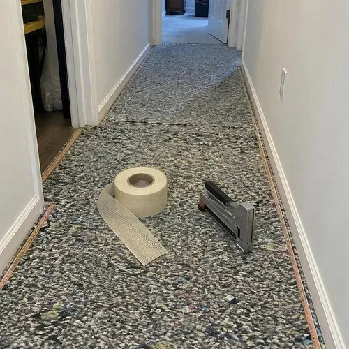 Carpet underpad stapled down with seam tape ready for installation