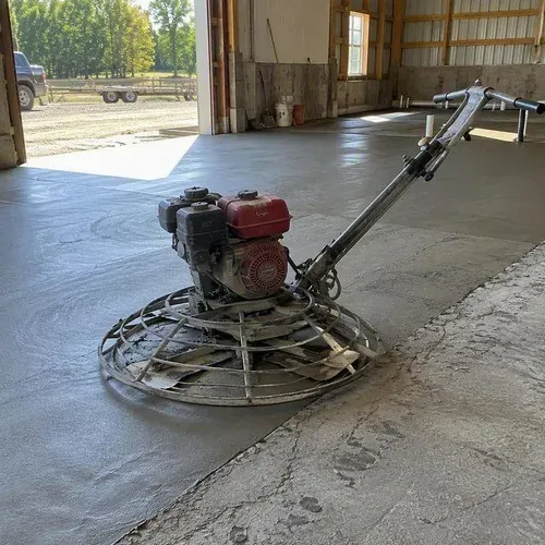 Power trowel finishing a new concrete floor slab