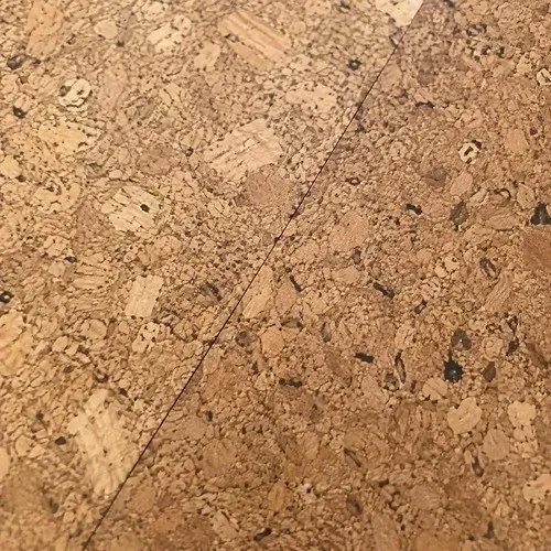 Close-up of cork flooring texture across a tight seam