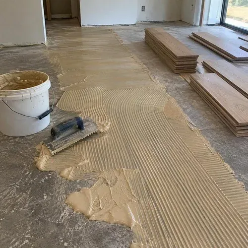 Urethane adhesive troweled on a concrete slab for glue-down engineered hardwood