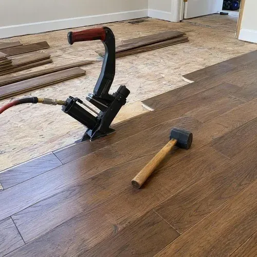 Wide plank hardwood installed in a large open room, typical of Puslinch custom homes