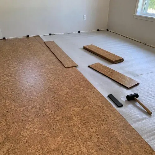 Floating cork click planks assembled over underlayment