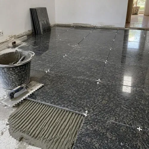Granite floor partly laid with spacers and open grout joints