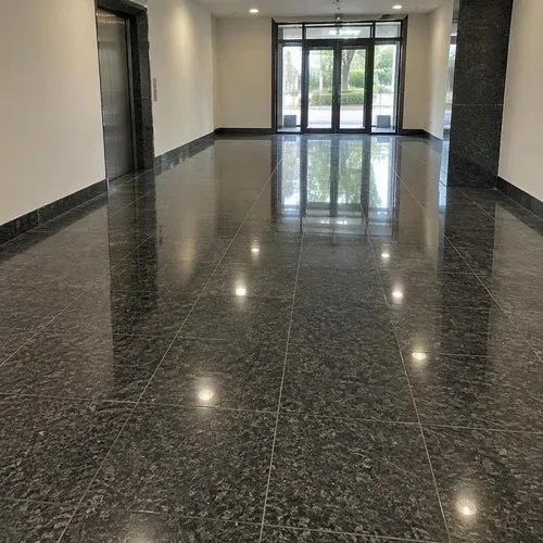 Dark granite flooring installed in a commercial entrance lobby
