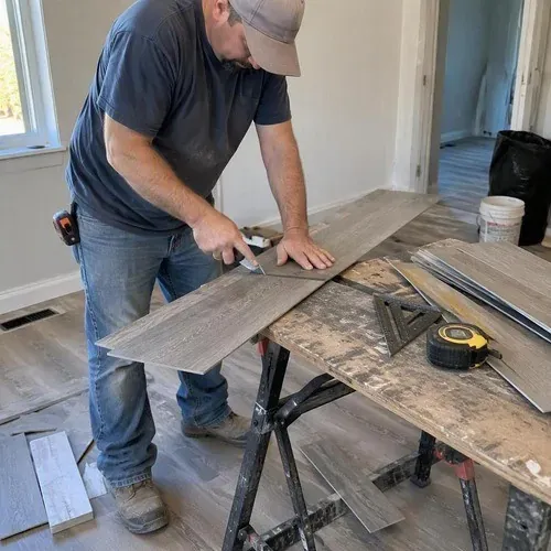 Vinyl plank being cut for a Waterloo rental unit turnover