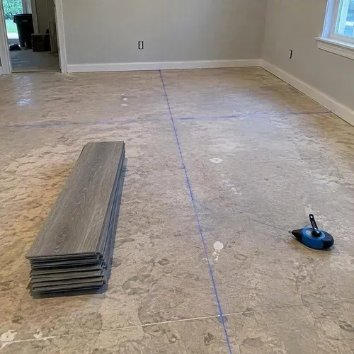 Chalk layout lines snapped on the subfloor before luxury vinyl tile installation