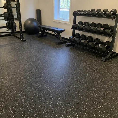 Black speckled rubber flooring installed in a weight room