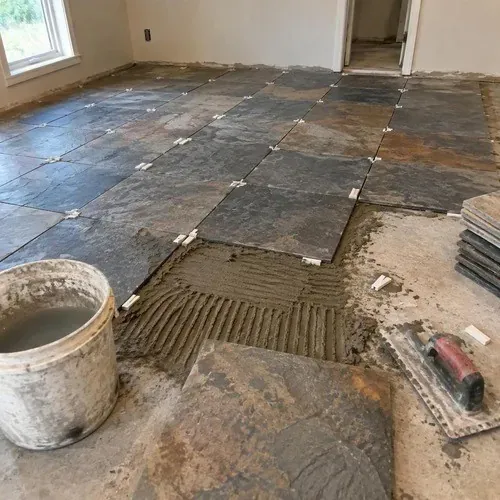 Ungauged slate tiles bedded in mortar and adjusted level