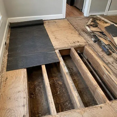 Old subfloor opened up to fix squeaks and soft spots in an Acton home