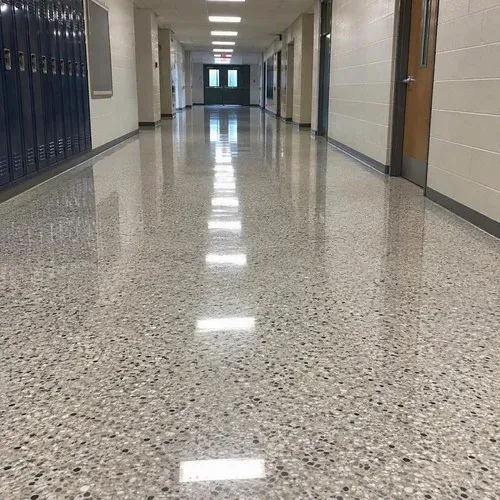Polished terrazzo floor in a commercial corridor reflecting the ceiling lights